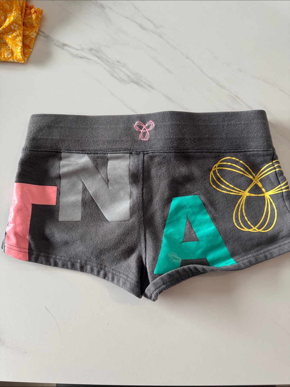 Aritiza Charcoal TNA Shorts with Teal, Pink & Gold Accents